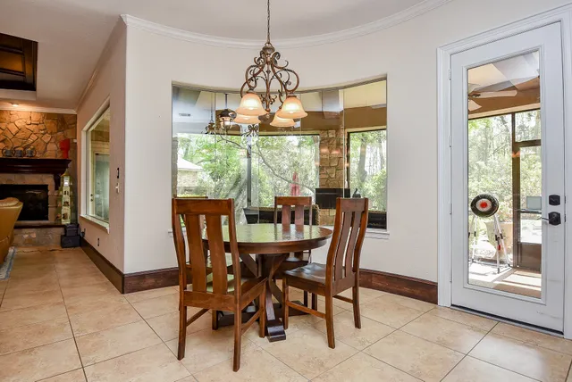 a dining room with furniture a chandelier and window