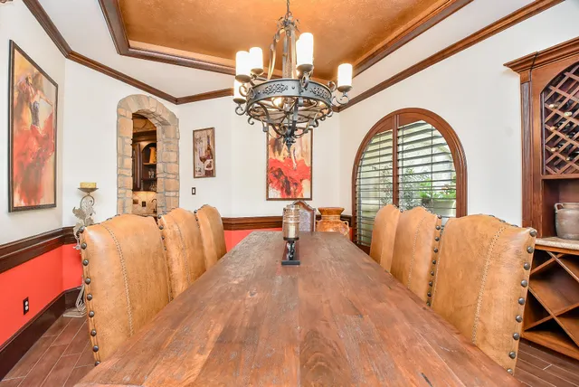 a living room with furniture chandelier and a large window