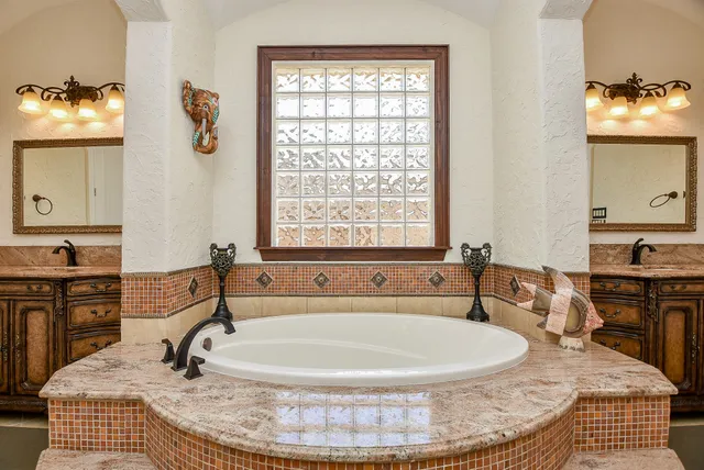 a bath tub sitting in a bathroom next to a window