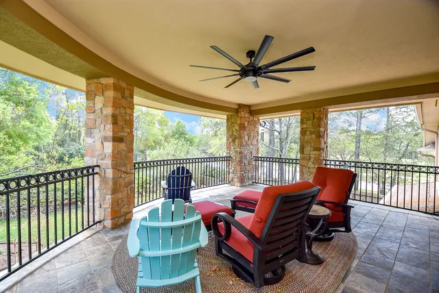 a living room with furniture and a floor to ceiling window
