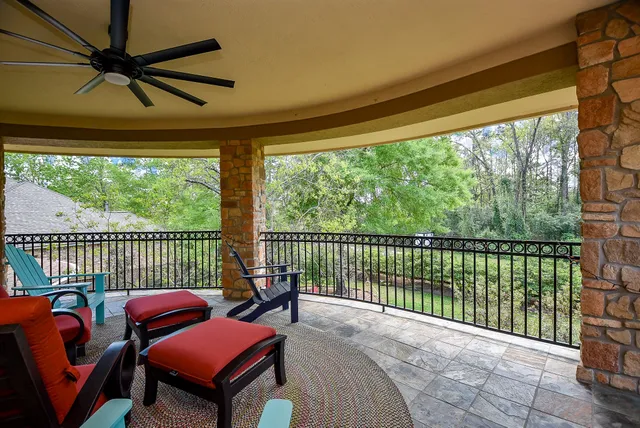 a balcony with chairs and a table