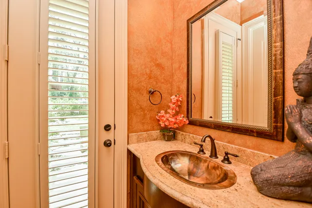a bathroom with a sink a mirror and a window