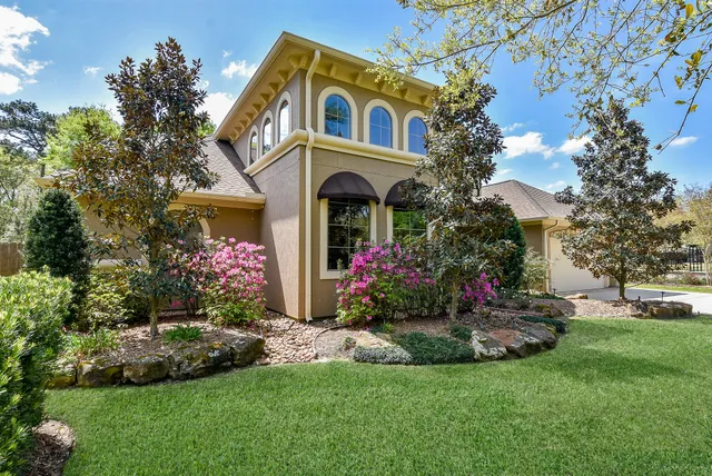 a front view of a house with a garden