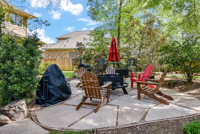a view of a backyard with sitting area and garden
