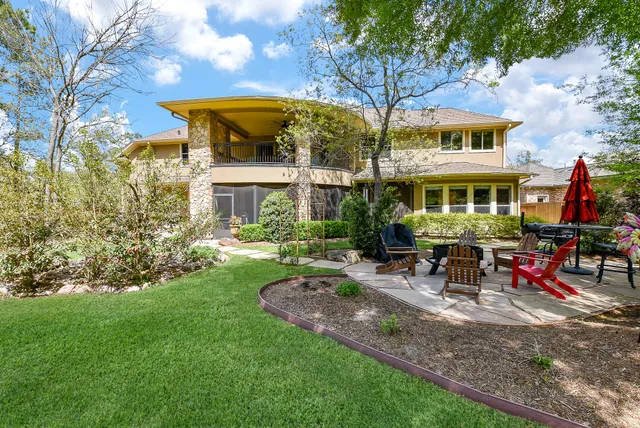 a view of a chairs and table in backyard of the house
