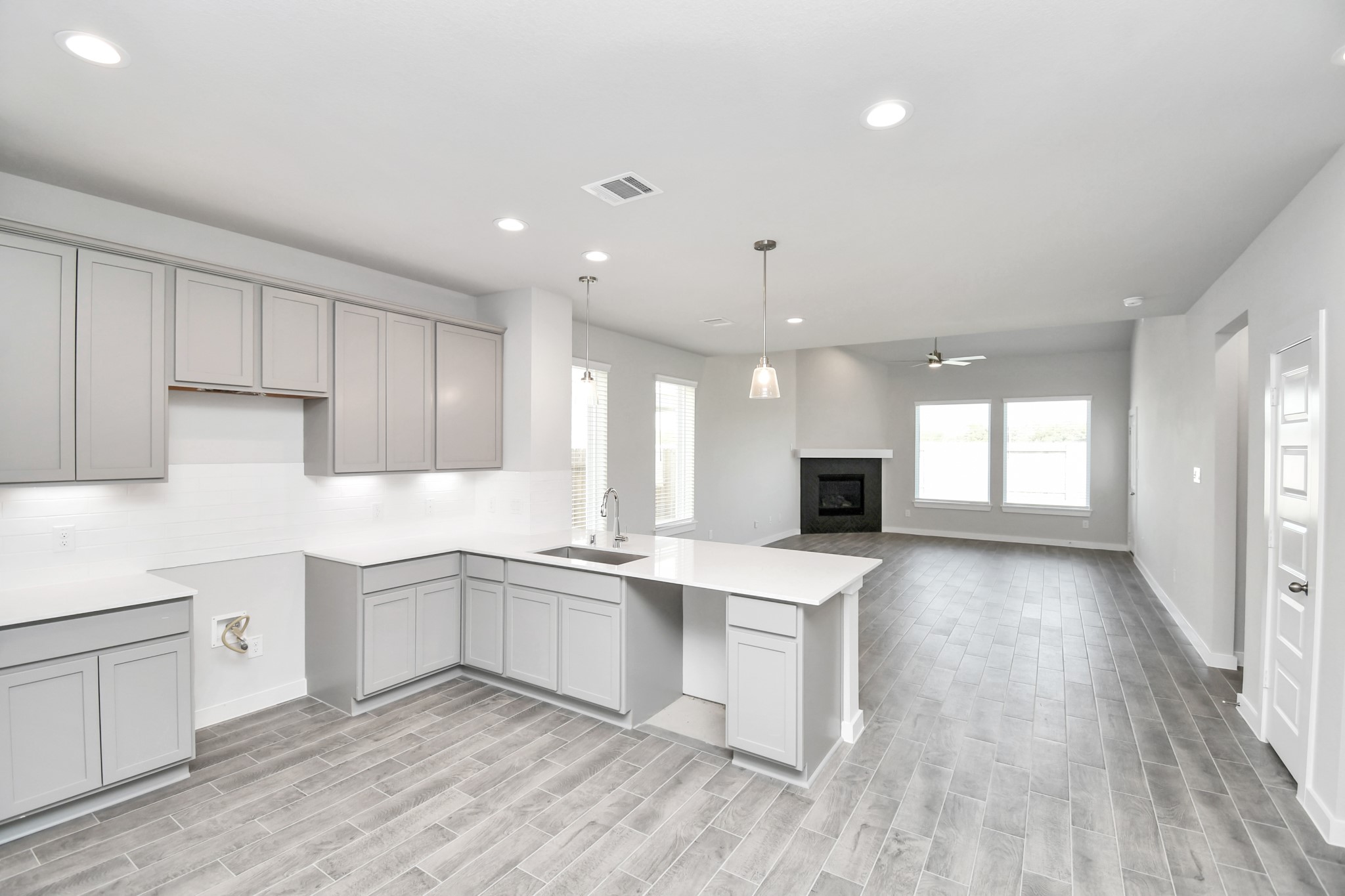 14823 Surfbird Lane Houston, TX 77049 - Photo 12 of 45 The extended counter area adds both practicality and style, making meal preparation a breeze. Every detail is thoughtfully designed to enhance the kitchen's functionality and aesthetic appeal.