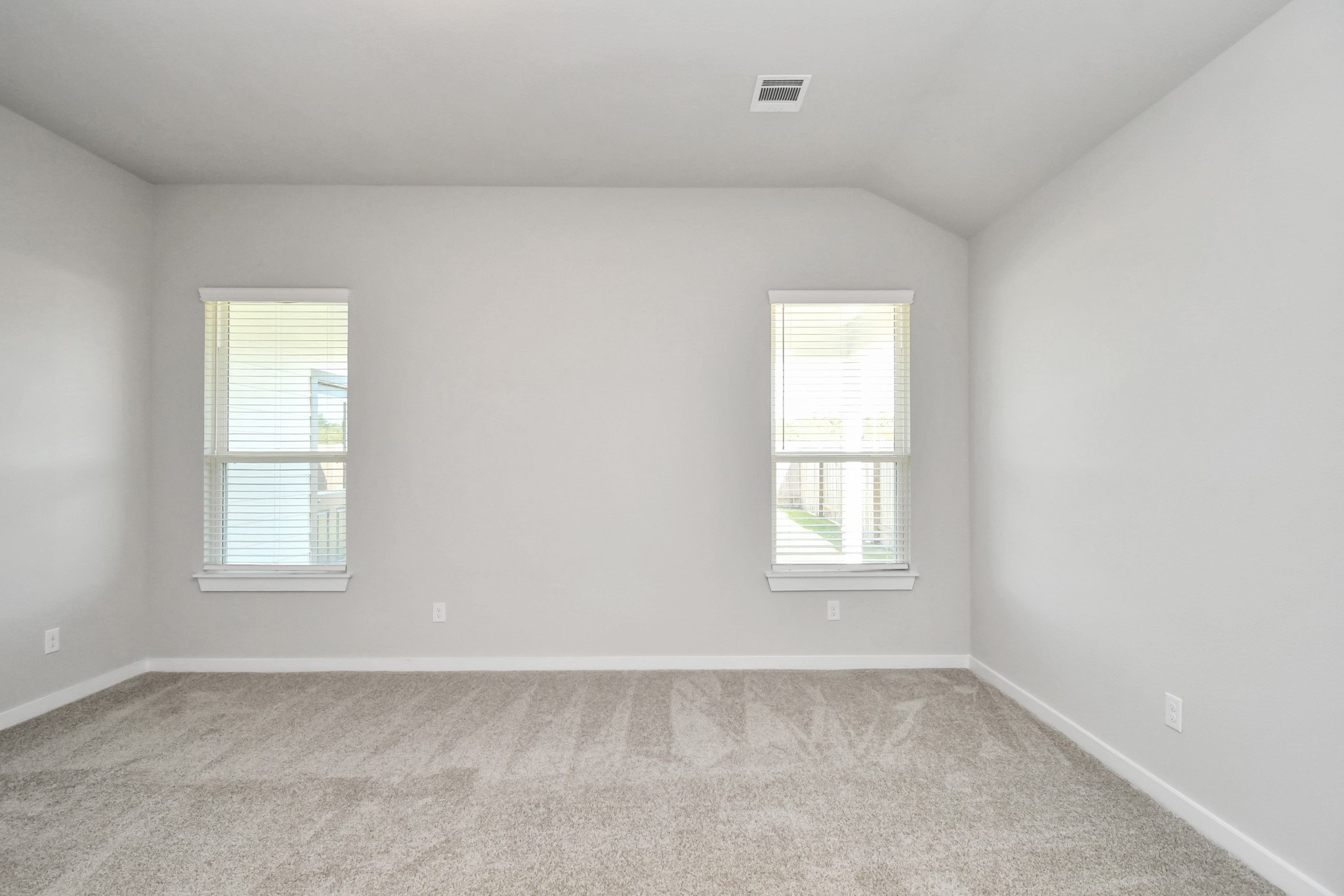 14823 Surfbird Lane Houston, TX 77049 - Photo 21 of 45 Escape to tranquility in this spacious primary room, adorned with plush carpeting and bathed in the soothing hues of warm paint colors, creating a cozy retreat for relaxation.