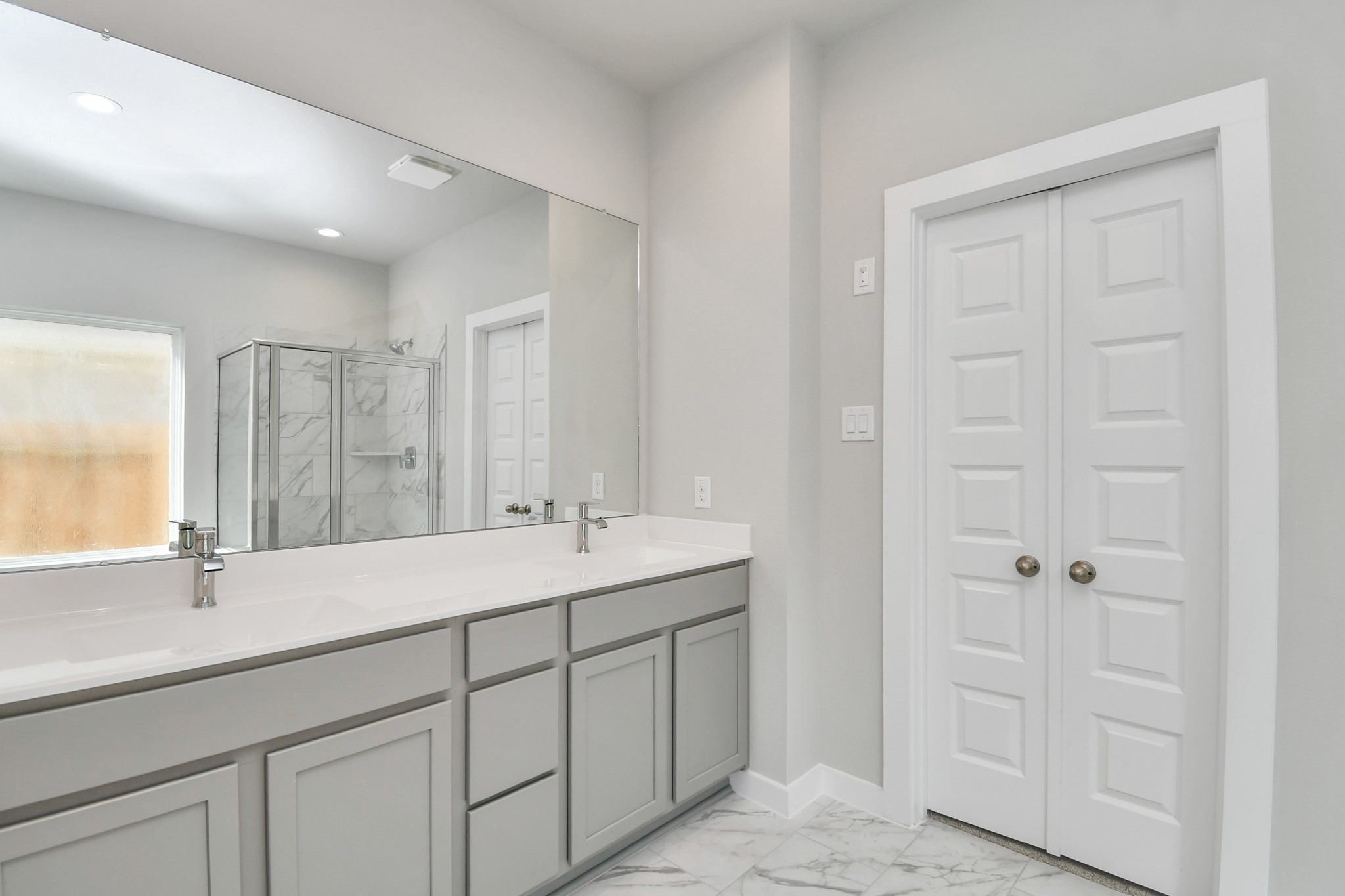 14823 Surfbird Lane Houston, TX 77049 - Photo 25 of 45 Elevate your daily routine at the elegant vanity, now equipped with double sinks, light countertops, modern hardware, and beautiful recessed lights.