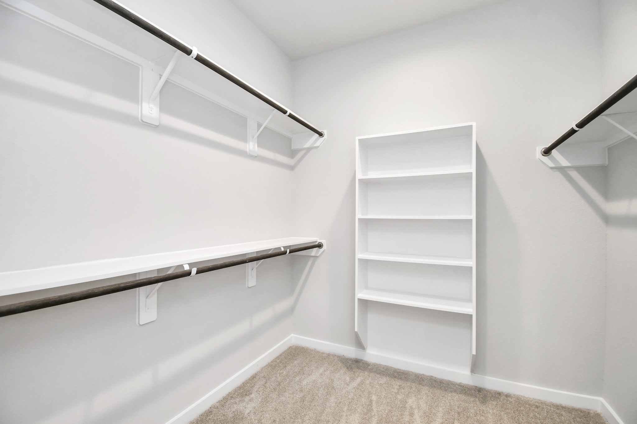 14823 Surfbird Lane Houston, TX 77049 - Photo 26 of 45 Walk-in closet that epitomizes luxury and practicality. This generously sized space features built-in shelving, offering abundant room for impeccable organization. High ceilings and recessed lighting create a bright and welcoming ambiance.