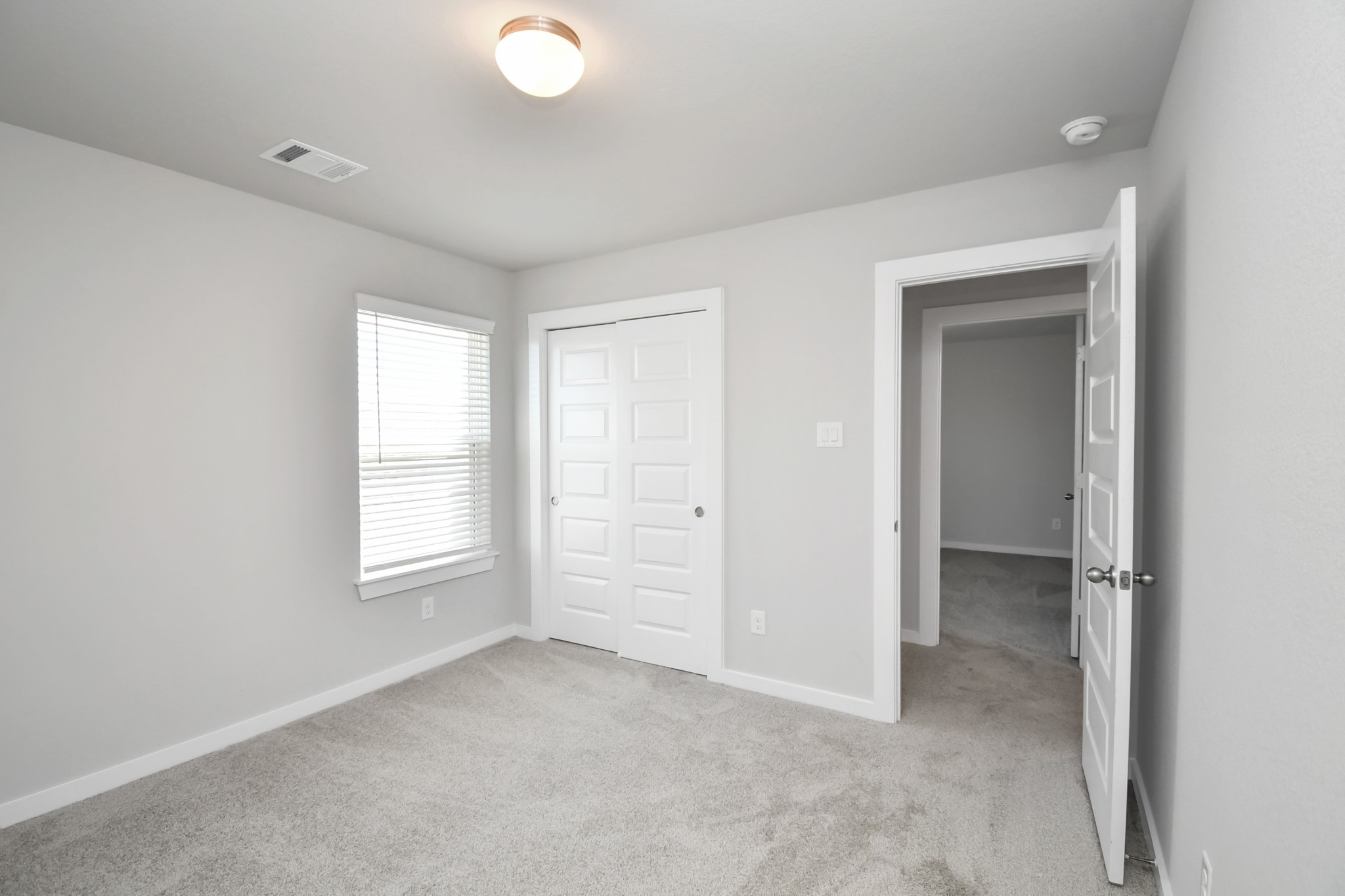 14823 Surfbird Lane Houston, TX 77049 - Photo 33 of 45 Generously sized secondary bedrooms featuring spacious closets, soft and inviting carpeting underfoot, large windows allowing plenty of natural light, and the added touch of privacy blinds for your personal retreat.