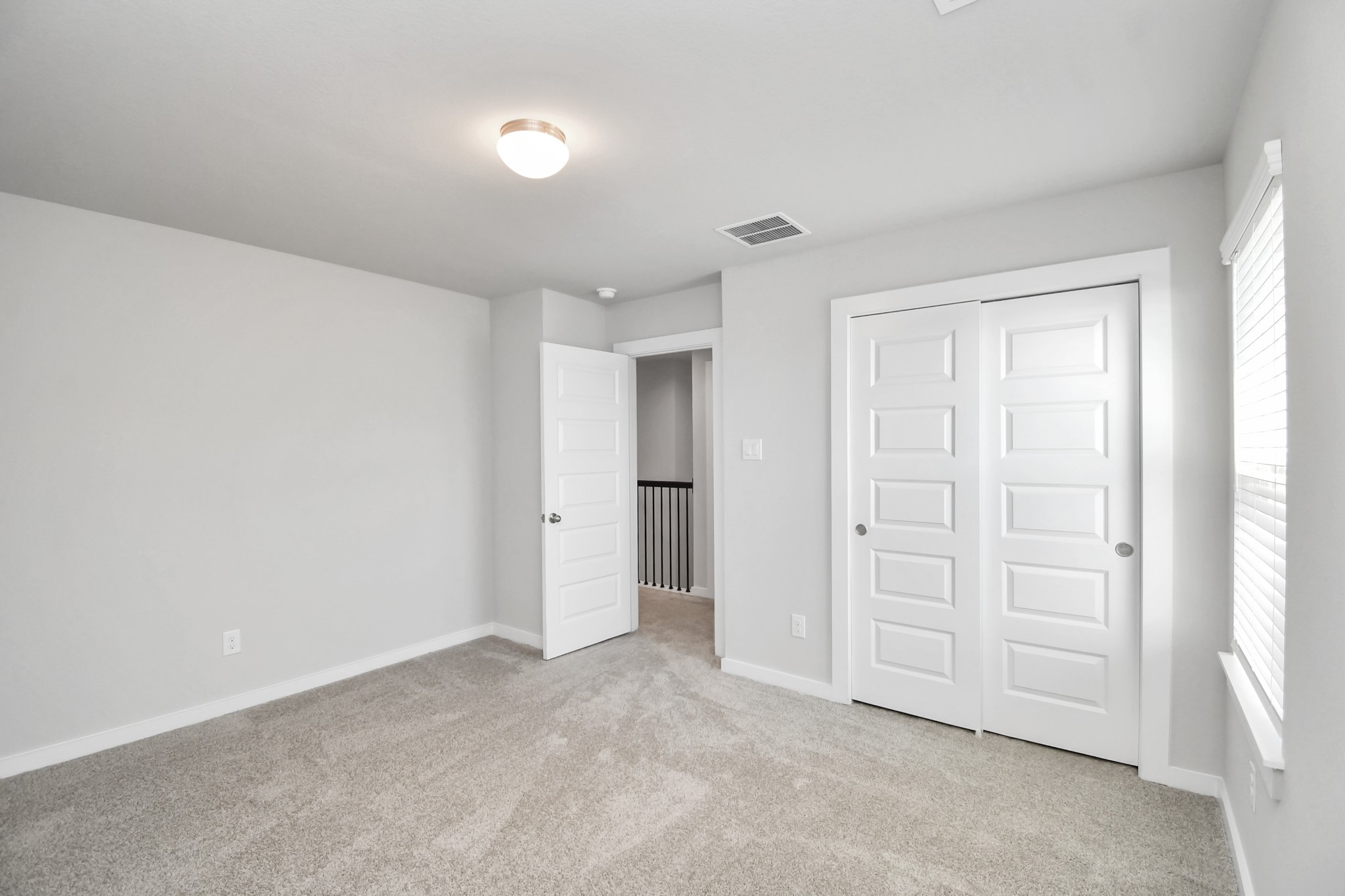 14823 Surfbird Lane Houston, TX 77049 - Photo 36 of 45 Generously sized secondary bedrooms featuring spacious closets, soft and inviting carpeting underfoot, large windows allowing plenty of natural light, and the added touch of privacy blinds for your personal retreat.