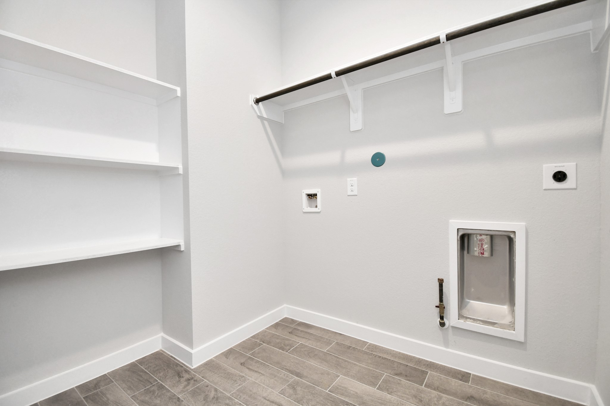 14823 Surfbird Lane Houston, TX 77049 - Photo 37 of 45 A perfect blend of functionality and comfort. Capture the essence of easy living with a first-floor laundry room, thoughtfully equipped with shelving for effortless organization. Both electric and gas connections available.