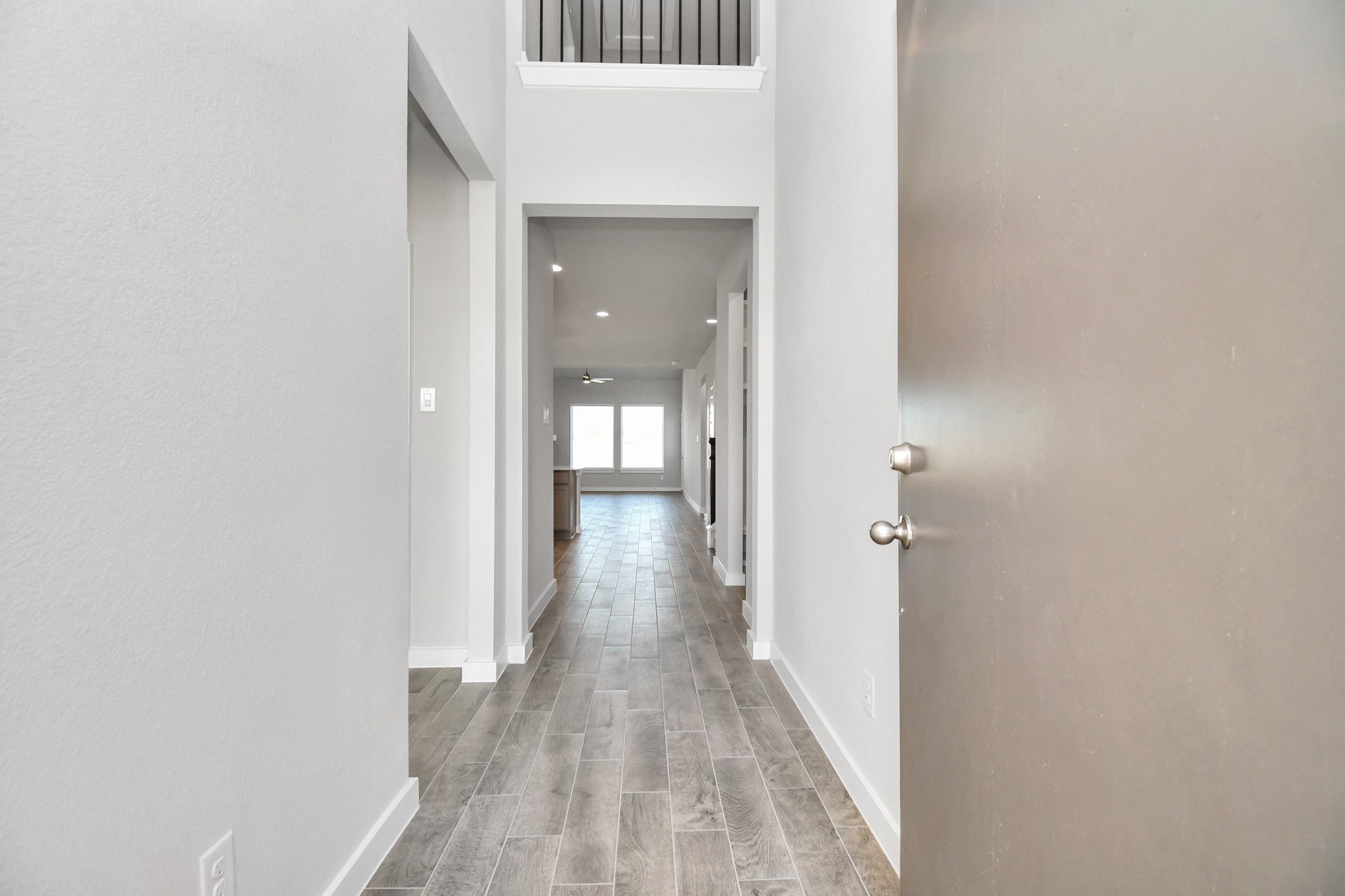 14823 Surfbird Lane Houston, TX 77049 - Photo 6 of 45 As you step into the threshold of this luxurious home, you'll soon be welcomed by an elegant glass door (to be installed). Inside, soaring ceilings amplify the spaciousness, while the refined wood-look tile flooring and oversized baseboards exude sophistication and charm.