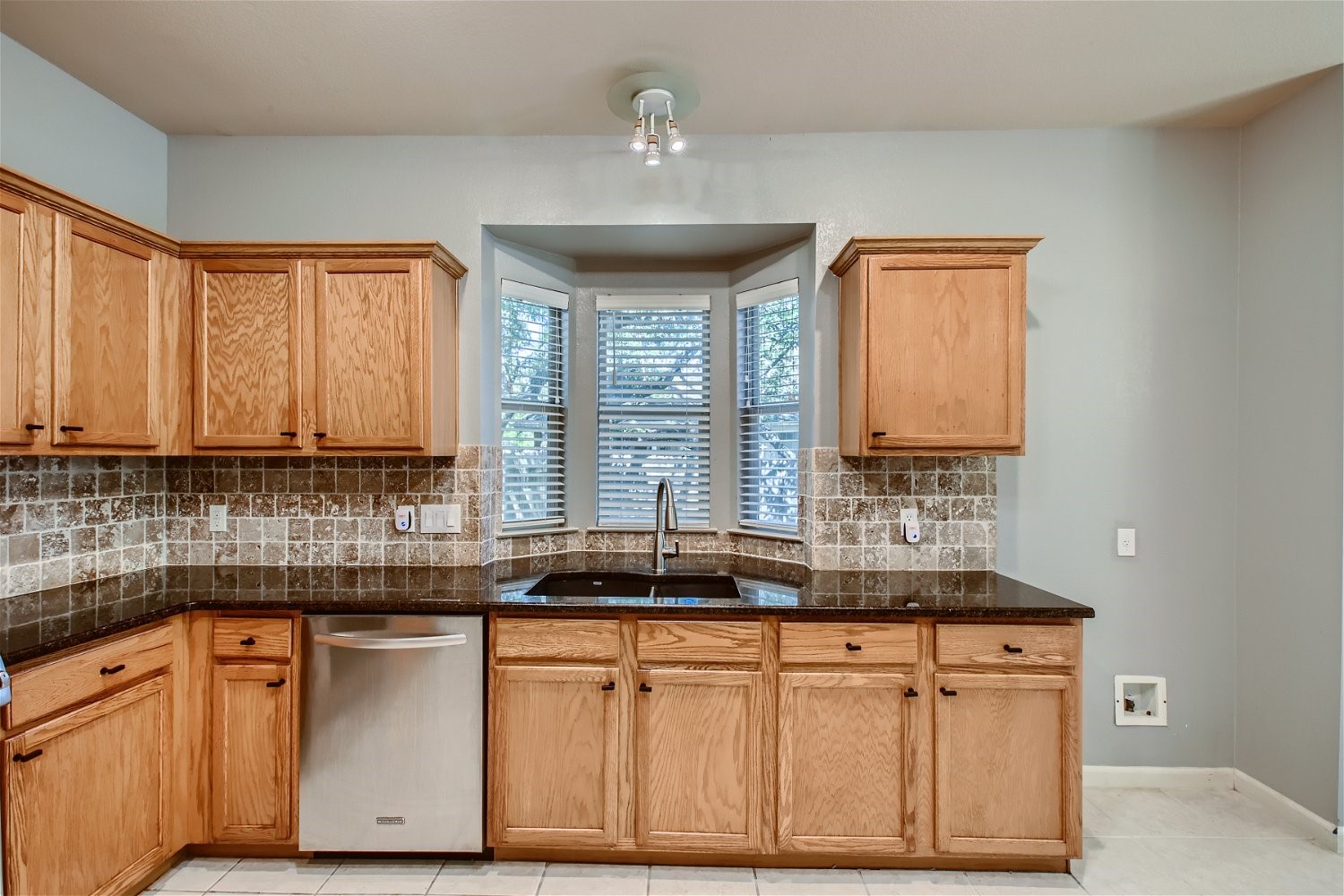 5320 Spirea Cove Austin, TX 78749 - Photo 8 of 28 a kitchen with stainless steel appliances granite countertop a sink a stove and a microwave