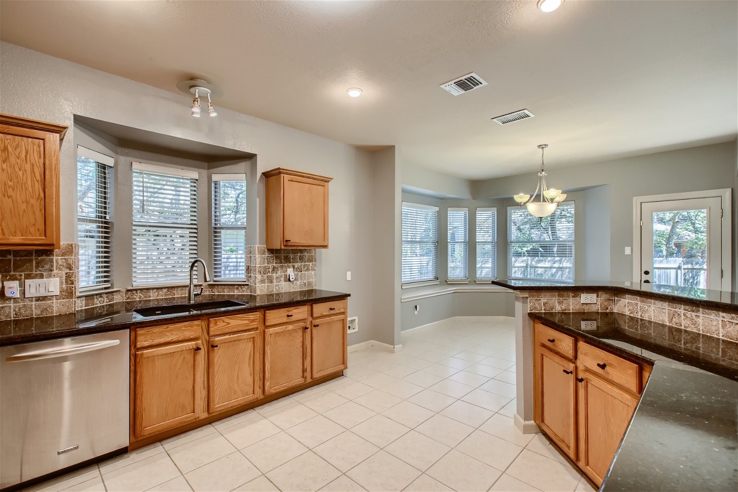 5320 Spirea Cove Austin, TX 78749 - Photo 9 of 28 a large kitchen with granite countertop a sink and cabinets