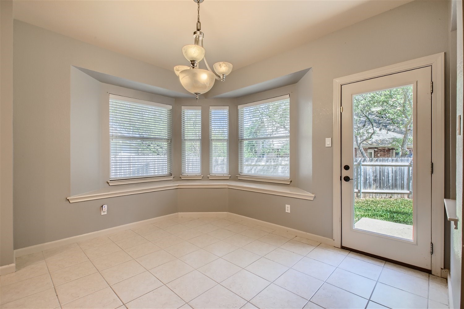 5320 Spirea Cove Austin, TX 78749 - Photo 10 of 28 an empty room with chandelier and windows