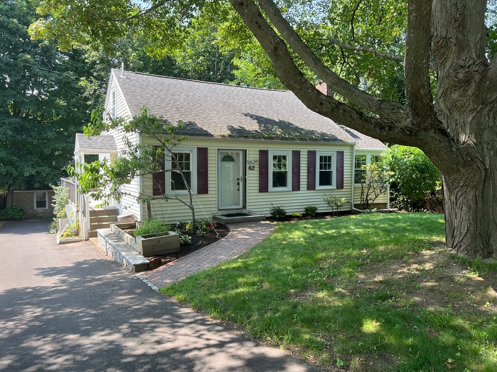 a view of a house with yard and a garden