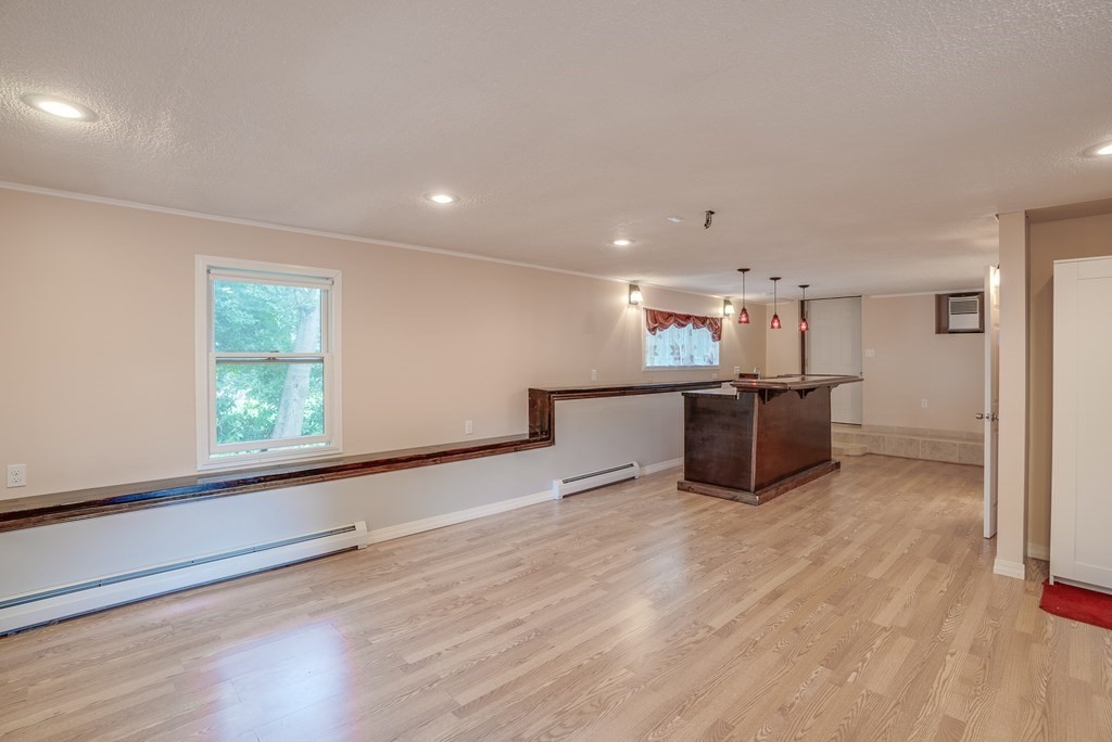 62 Gleason Road Lexington, MA 02420 - Photo 27 of 39 a view of an empty room with wooden floor and a window