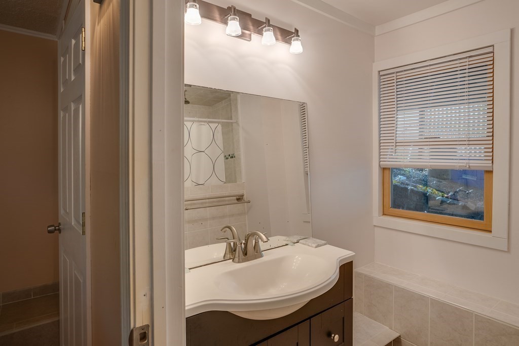 62 Gleason Road Lexington, MA 02420 - Photo 30 of 39 a bathroom with a sink and a mirror