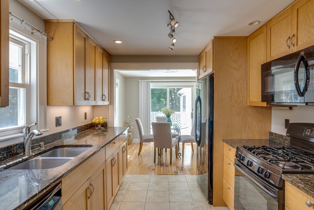 62 Gleason Road Lexington, MA 02420 - Photo 6 of 39 a kitchen with granite countertop a sink stainless steel appliances wooden floor and cabinets