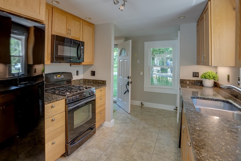 62 Gleason Road Lexington, MA 02420 - Photo 7 of 39 a kitchen with stainless steel appliances granite countertop a stove a sink and a microwave