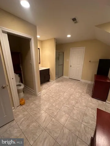 a view of a hallway with a kitchen