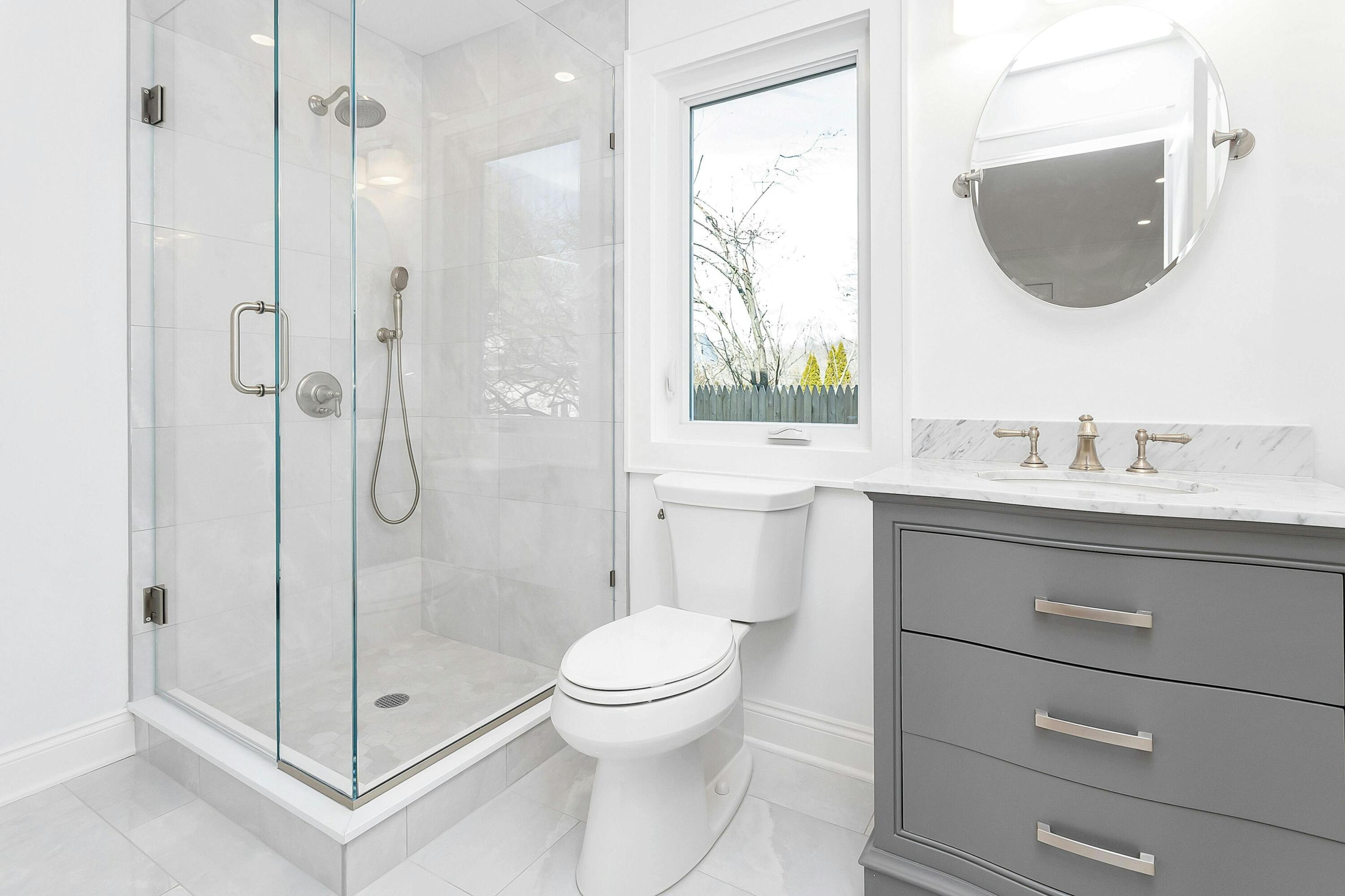 34 Crimmins Road Darien, CT 06820 - Photo 11 of 28 a bathroom with a shower a sink a toilet and a mirror