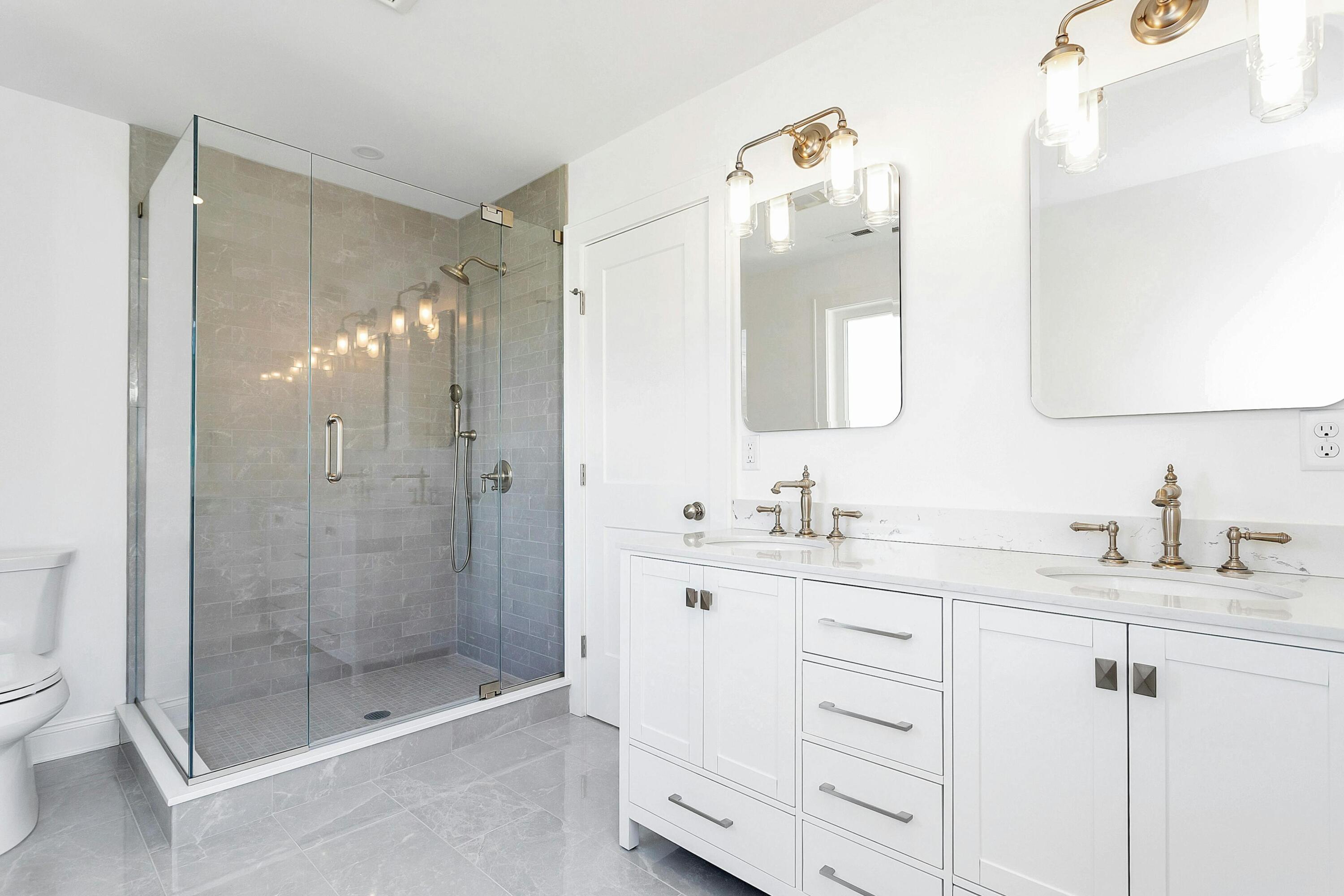 34 Crimmins Road Darien, CT 06820 - Photo 15 of 28 a bathroom with a granite countertop sink mirror and shower