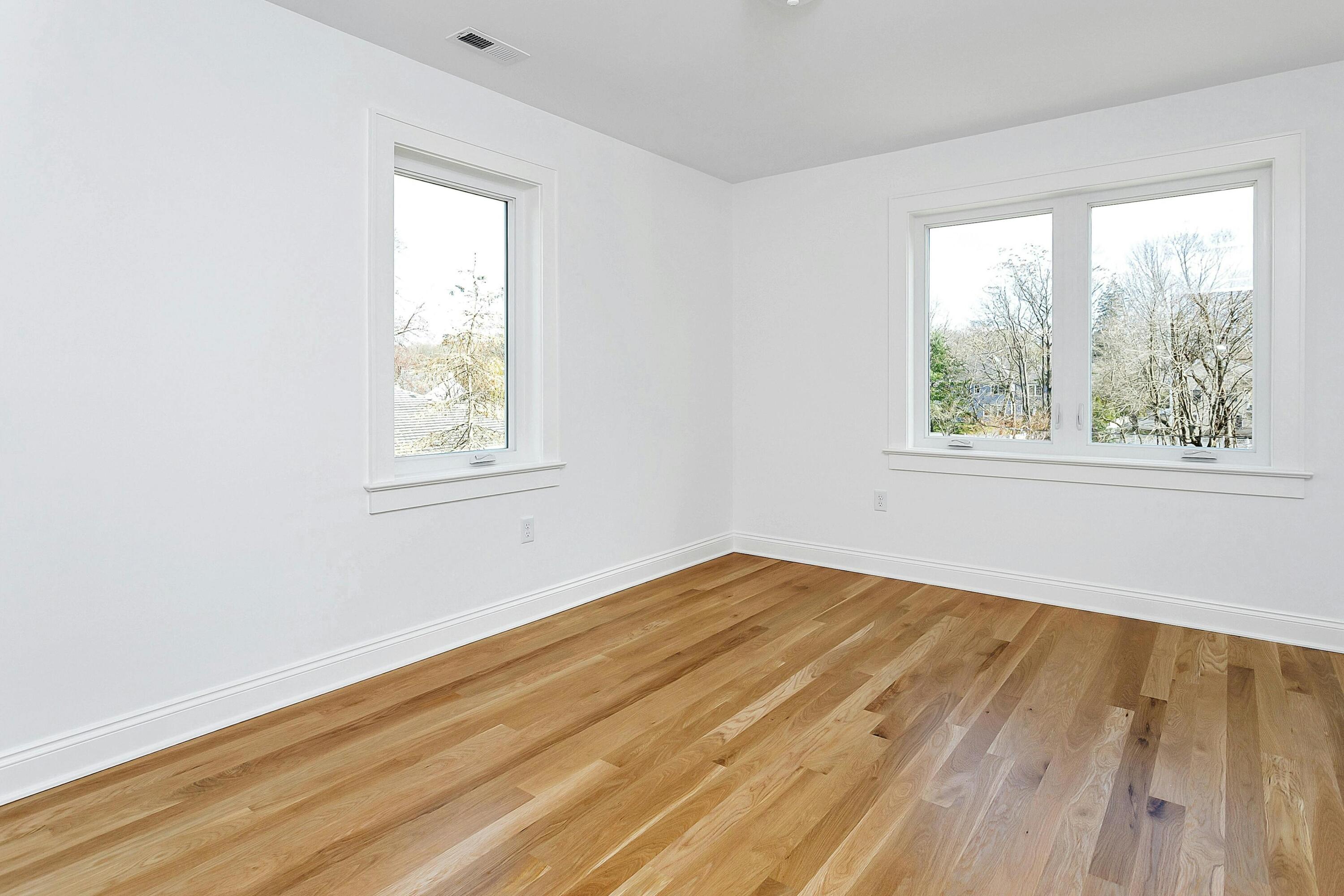 34 Crimmins Road Darien, CT 06820 - Photo 16 of 28 an empty room with wooden floor and windows