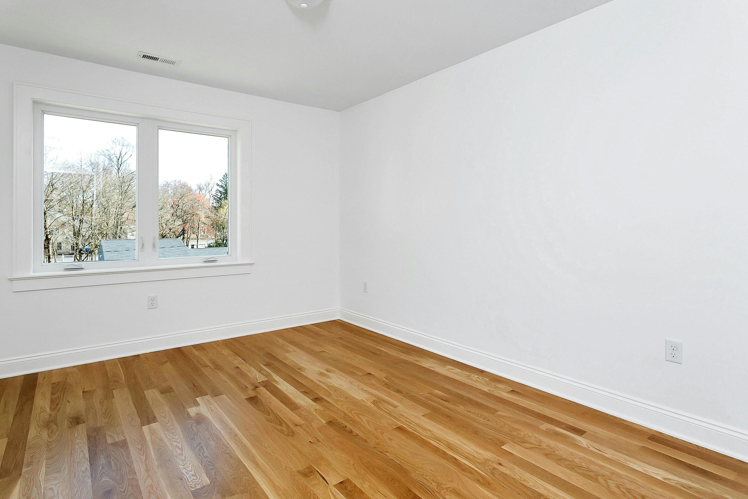 34 Crimmins Road Darien, CT 06820 - Photo 17 of 28 an empty room with wooden floor and windows