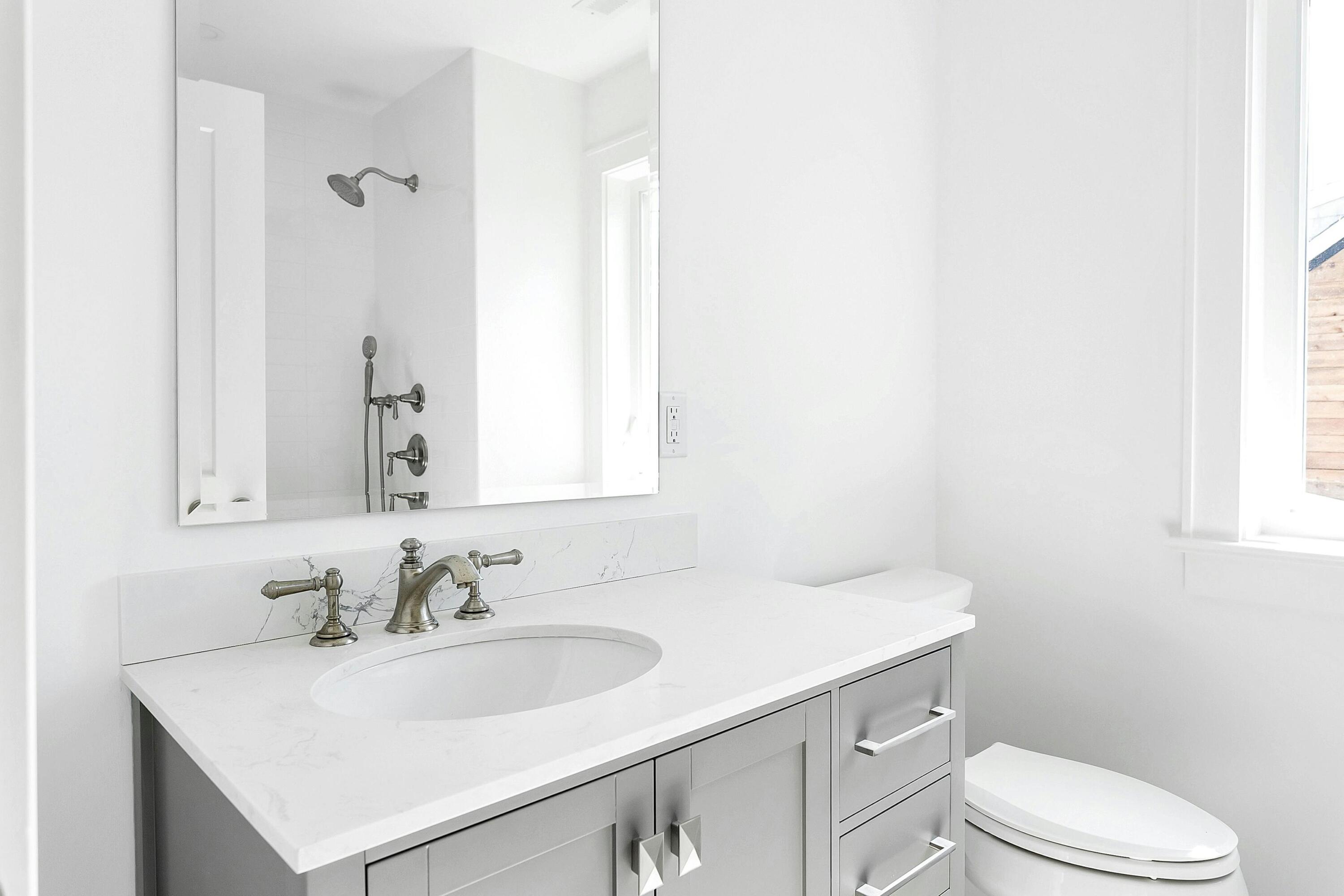 34 Crimmins Road Darien, CT 06820 - Photo 18 of 28 a bathroom with a sink toilet vanity and a mirror