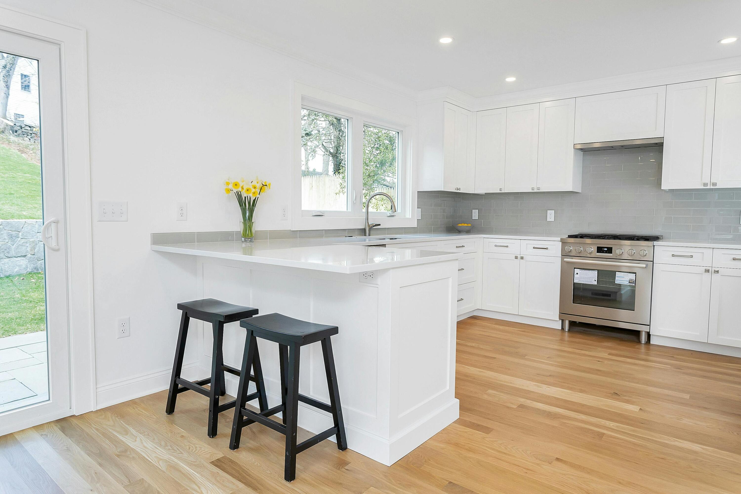 34 Crimmins Road Darien, CT 06820 - Photo 8 of 28 a kitchen with stainless steel appliances a sink a stove a refrigerator cabinets and wooden floor