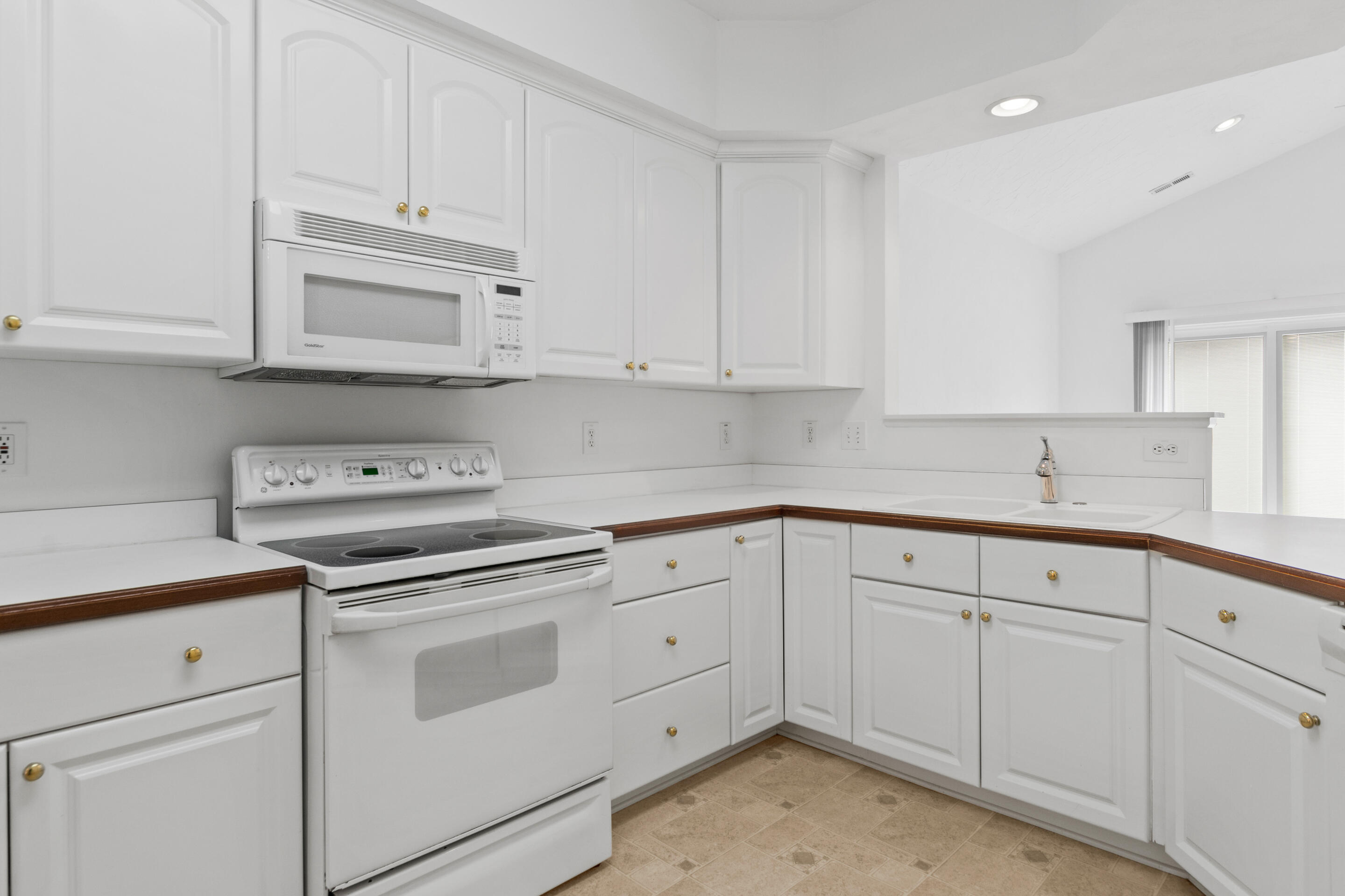 2243 Countryside Road Northwest Roanoke, VA 24017 - Photo 10 of 38 a kitchen with white cabinets and white appliances