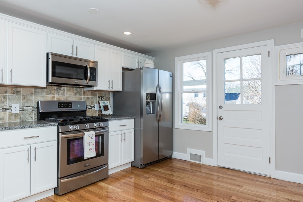 54 Oregon Street Springfield, MA 01118 - Photo 4 of 30 a kitchen with stainless steel appliances granite countertop a stove a refrigerator and a microwave