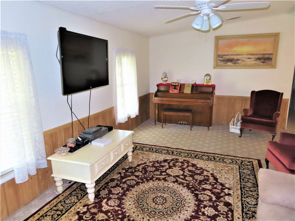 629 Marlin Circle Barefoot Bay, FL 32976 - Photo 11 of 34 a living room with furniture and a flat screen tv