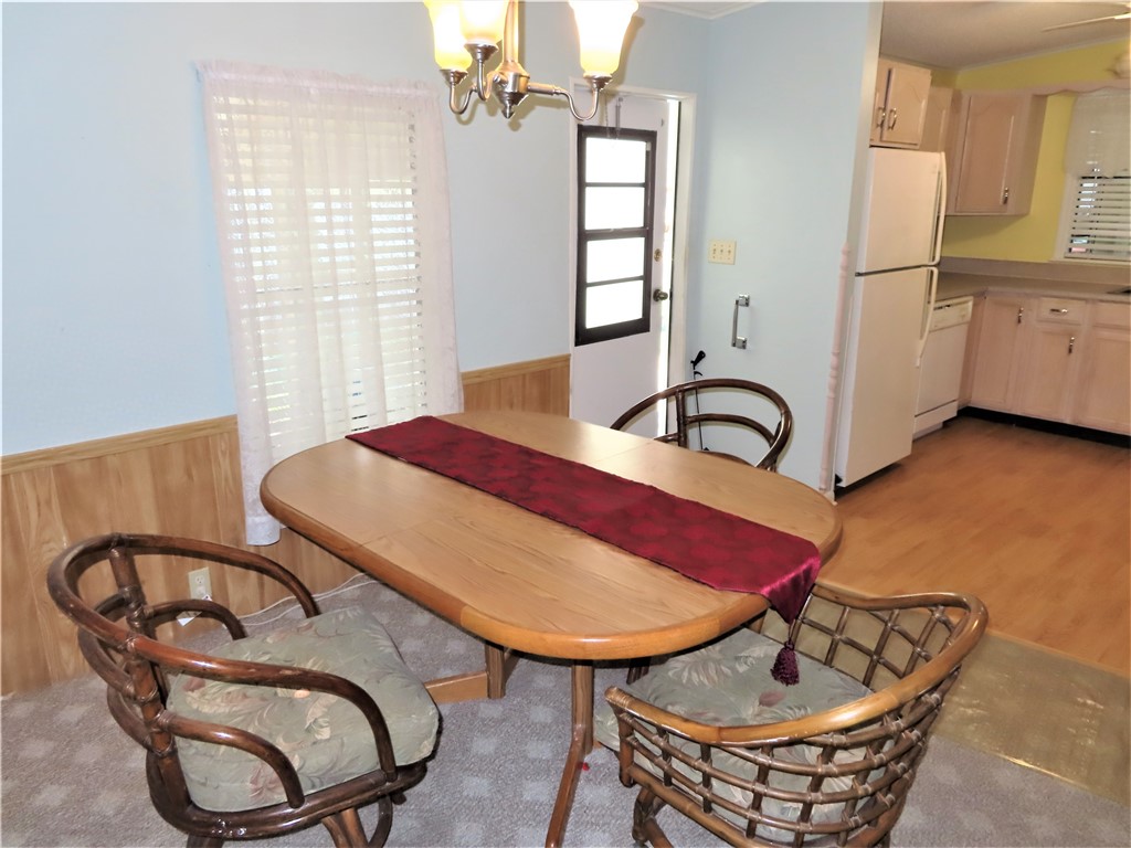 629 Marlin Circle Barefoot Bay, FL 32976 - Photo 14 of 34 a view of a dining room with furniture window and wooden floor