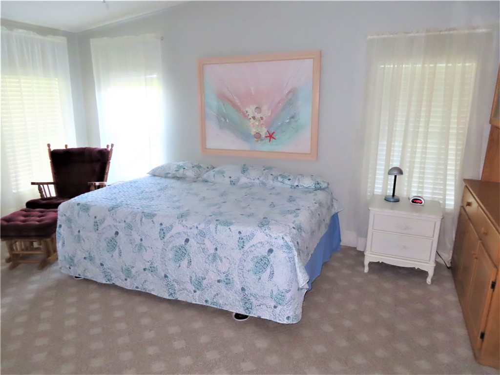 629 Marlin Circle Barefoot Bay, FL 32976 - Photo 16 of 34 a bedroom with a bed and a couch