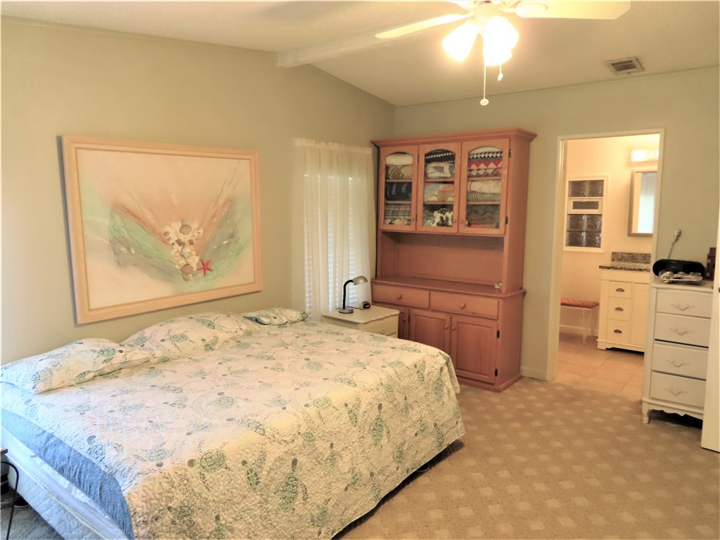 629 Marlin Circle Barefoot Bay, FL 32976 - Photo 17 of 34 a bedroom with a bed and cabinets
