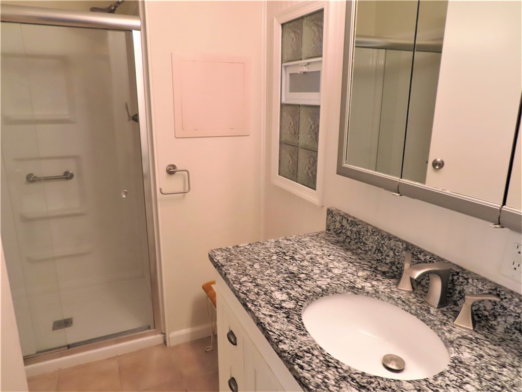 629 Marlin Circle Barefoot Bay, FL 32976 - Photo 19 of 34 a bathroom with a granite countertop sink and a mirror