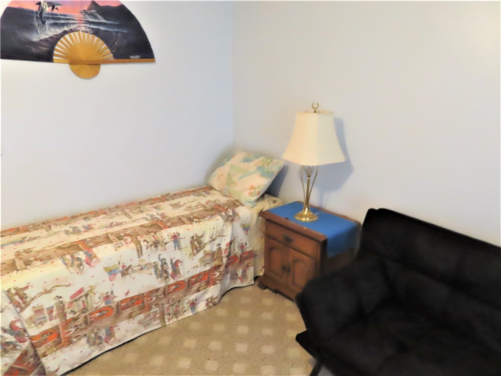 629 Marlin Circle Barefoot Bay, FL 32976 - Photo 23 of 34 a bed sitting in a bedroom next to a window