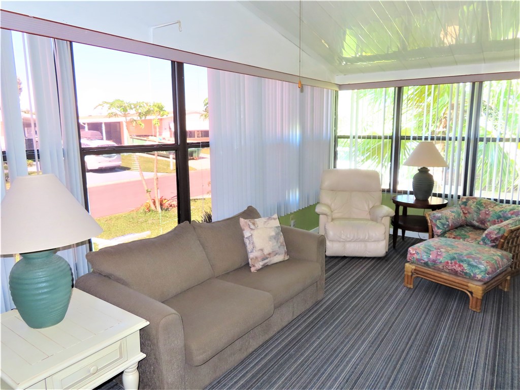 629 Marlin Circle Barefoot Bay, FL 32976 - Photo 28 of 34 a living room with furniture and a large window
