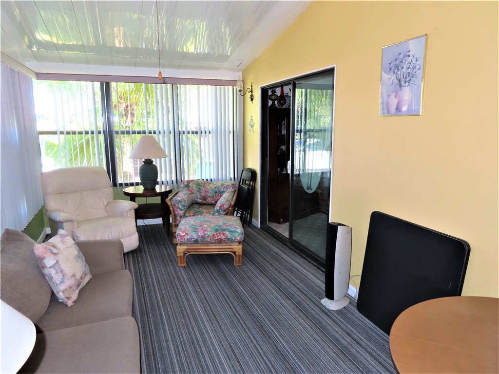 629 Marlin Circle Barefoot Bay, FL 32976 - Photo 29 of 34 a living room with furniture and a large window