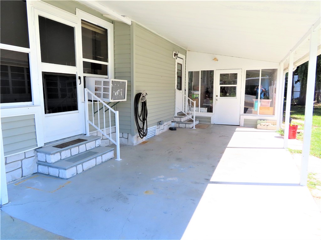 629 Marlin Circle Barefoot Bay, FL 32976 - Photo 3 of 34 a building outdoor space with patio furniture