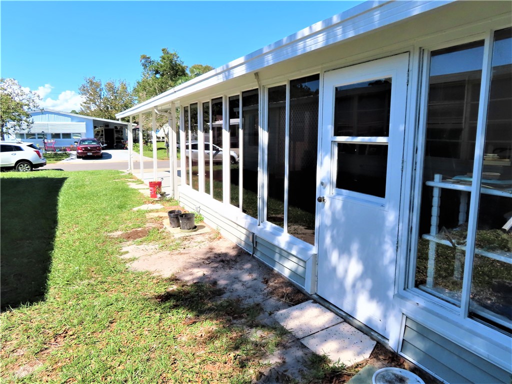 629 Marlin Circle Barefoot Bay, FL 32976 - Photo 32 of 34 a view of a house with a yard and potted plants