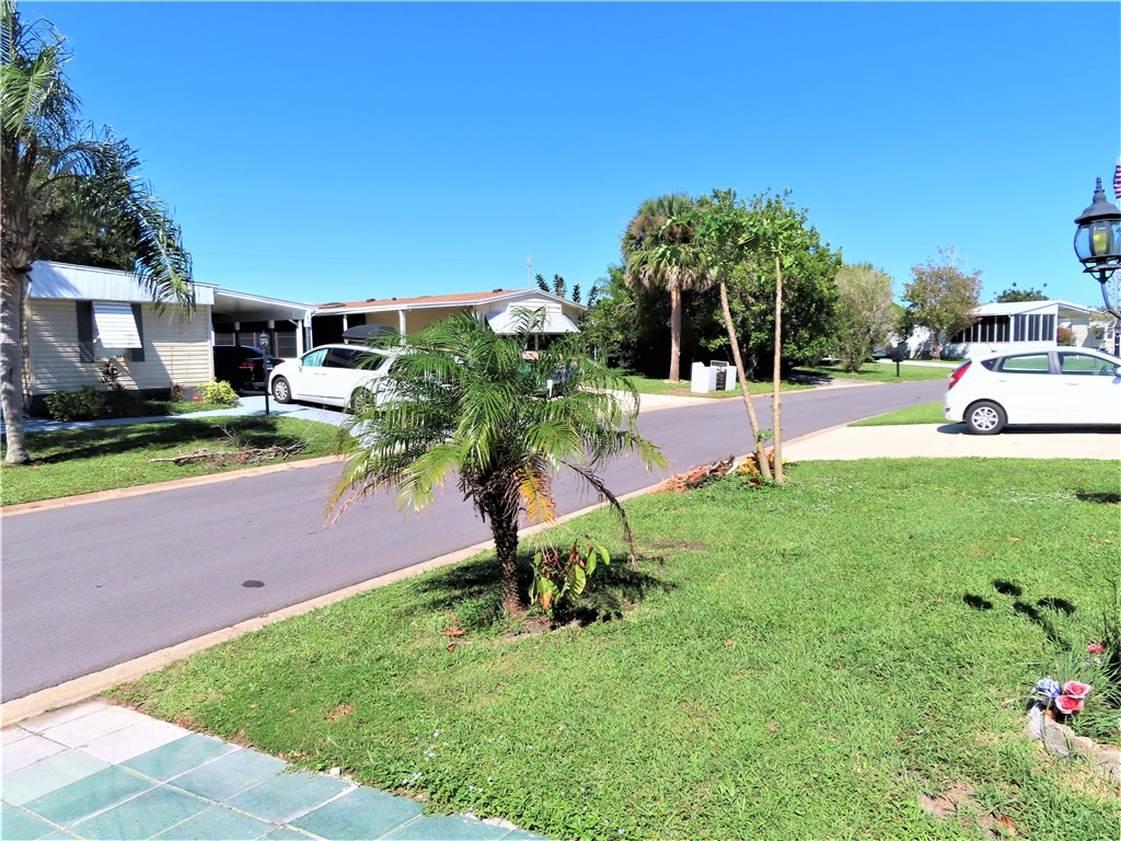 629 Marlin Circle Barefoot Bay, FL 32976 - Photo 33 of 34 a view of backyard with a garden and entertaining space