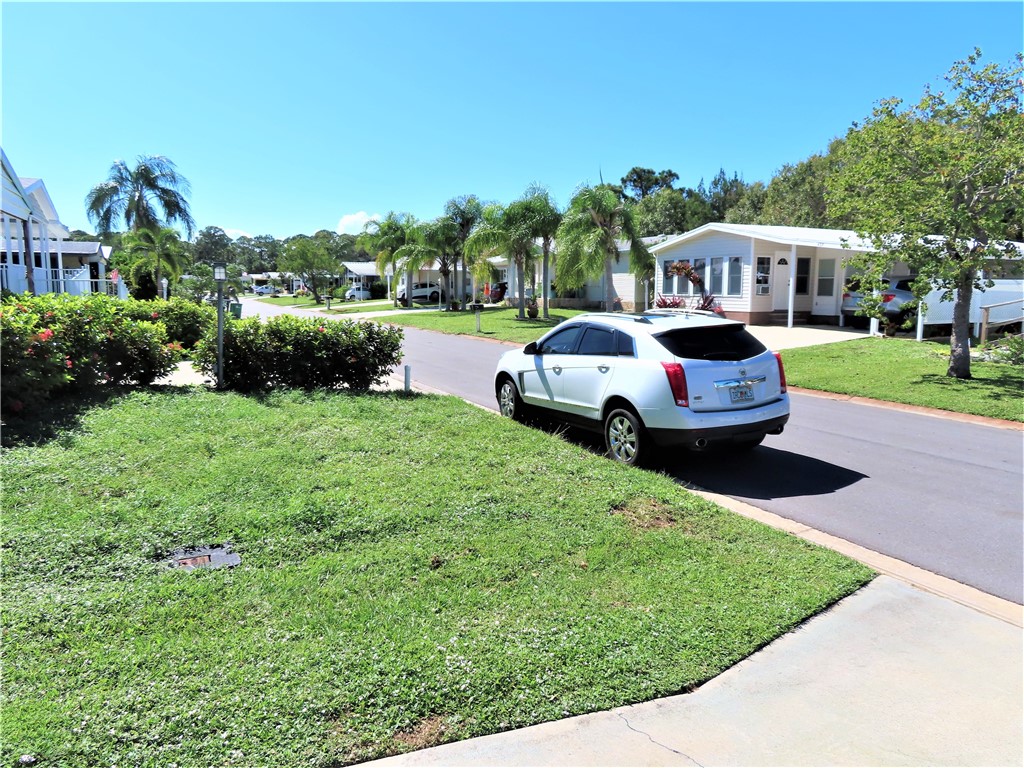 629 Marlin Circle Barefoot Bay, FL 32976 - Photo 34 of 34 a front view of a house with garden and porch