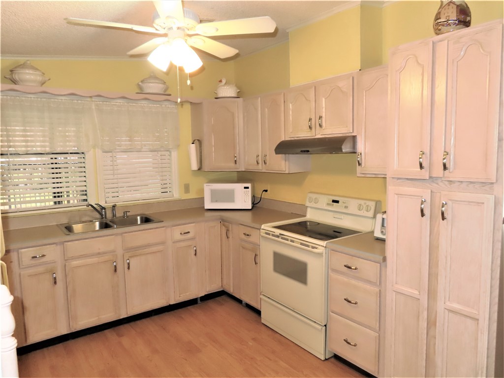 629 Marlin Circle Barefoot Bay, FL 32976 - Photo 6 of 34 a kitchen with appliances cabinets and a sink