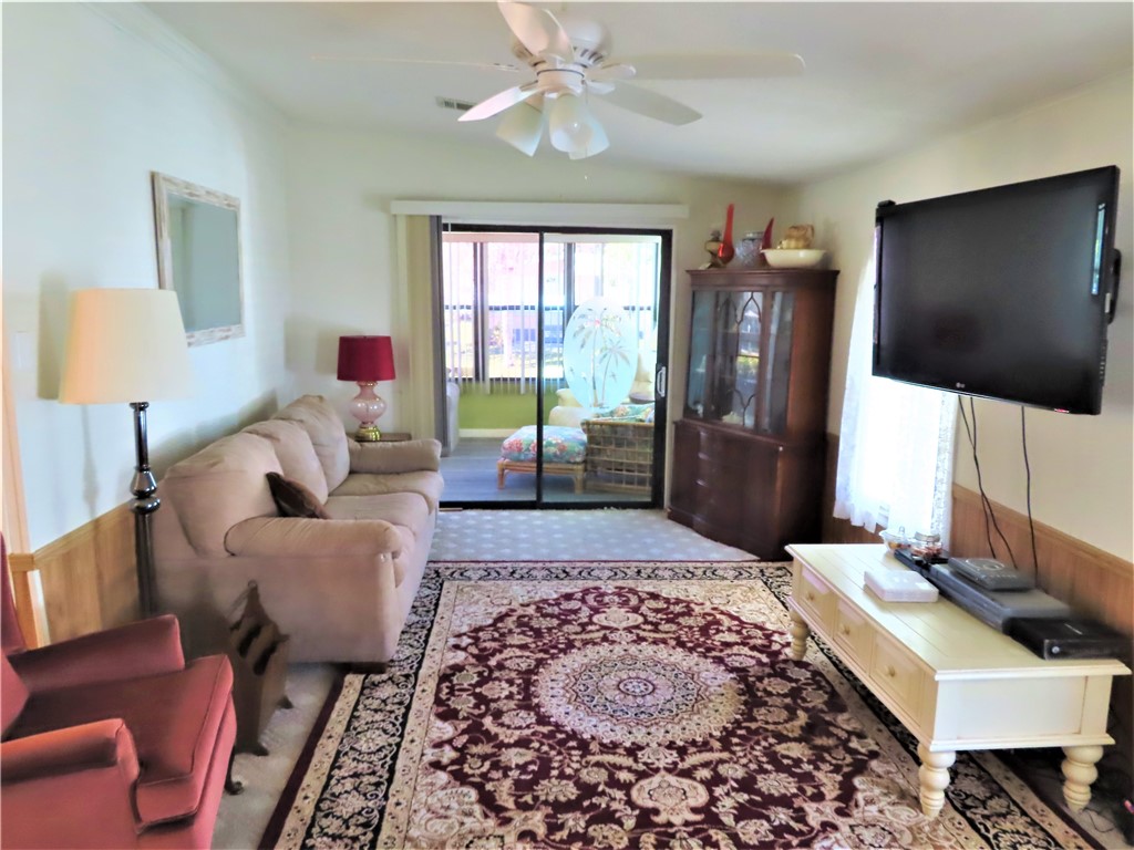 629 Marlin Circle Barefoot Bay, FL 32976 - Photo 8 of 34 a living room with furniture and a flat screen tv