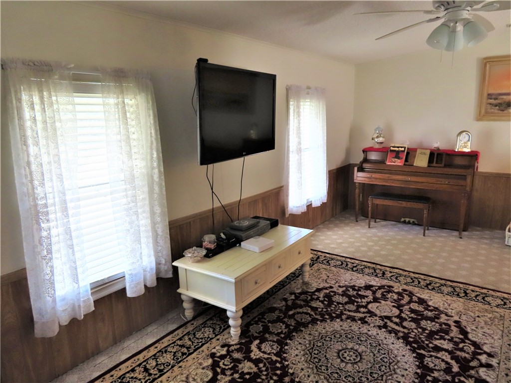 629 Marlin Circle Barefoot Bay, FL 32976 - Photo 9 of 34 a living room with a couch and a flat screen tv
