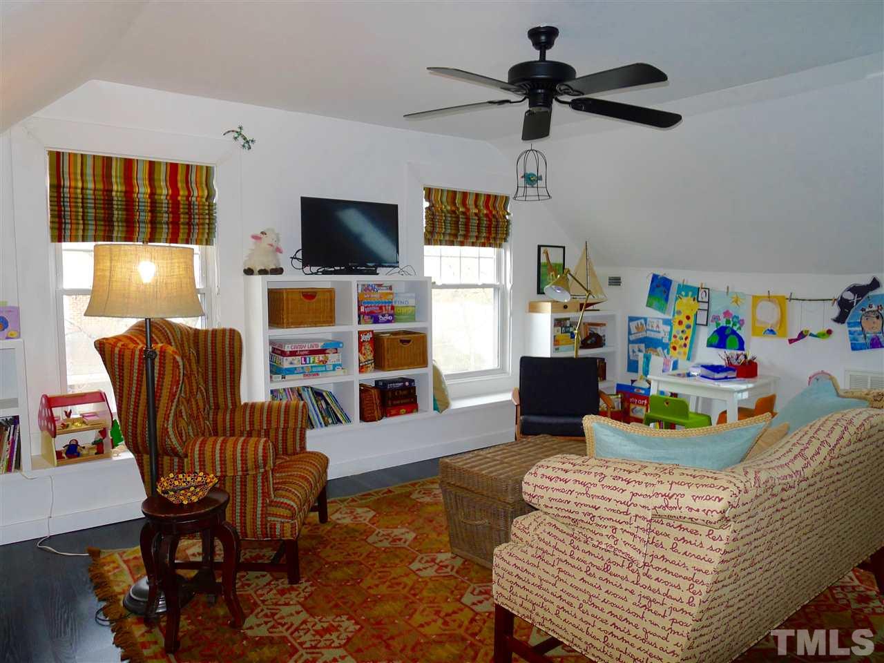 136 Woodburn Road, Unit 4 Raleigh, NC 27605 - Photo 14 of 18 a living room with furniture and a flat screen tv